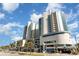 Resort's exterior view showing multiple stories with balconies, complemented by palm trees and an inviting entrance at 300 N Ocean Blvd. # 723, North Myrtle Beach, SC 29582