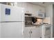 Compact kitchen featuring standard appliances, granite countertops, and ample cabinet space at 300 N Ocean Blvd. # 723, North Myrtle Beach, SC 29582