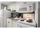 Cozy kitchen featuring white cabinets, countertops, and essential appliances at 300 N Ocean Blvd. # 723, North Myrtle Beach, SC 29582