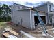 View of the attached garage with gray siding and white trim under construction at 3038 Palma Way, Myrtle Beach, SC 29579