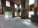 A living room during construction featuring a fireplace framed by studs and exterior views through windows at 3038 Palma Way, Myrtle Beach, SC 29579