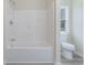 Bathroom featuring tub and shower combo, toilet, and window for natural light at 306 S Magnolia Ave., Andrews, SC 29510