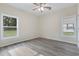 Bright bedroom featuring hardwood floors, neutral walls, ceiling fan, and double hung windows at 306 S Magnolia Ave., Andrews, SC 29510