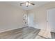 Bright bedroom featuring hardwood floors, neutral walls, a ceiling fan, and a white interior door at 306 S Magnolia Ave., Andrews, SC 29510