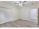 Bedroom with ceiling fan, closet, neutral walls, and wood look floors at 306 S Magnolia Ave., Andrews, SC 29510