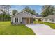 Charming single-story home with gray siding, covered parking, and a well-maintained front yard at 306 S Magnolia Ave., Andrews, SC 29510