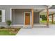 Inviting front porch showcasing a wooden door and covered carport at 306 S Magnolia Ave., Andrews, SC 29510