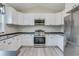 Well-lit kitchen featuring white cabinets, stainless steel appliances, and contemporary countertops at 306 S Magnolia Ave., Andrews, SC 29510