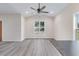 Bright Living Room with big window, ceiling fan, and wood-look floors at 306 S Magnolia Ave., Andrews, SC 29510