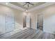 Main bedroom with tray ceiling, ceiling fan, recessed lighting, closet, and bathroom at 306 S Magnolia Ave., Andrews, SC 29510