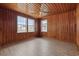 Sunlit bedroom with wood paneling and laminate floors, offering bright views at 3202 Inland St., North Myrtle Beach, SC 29582