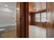Bright bedroom with wood-paneled walls and floors plus bright, white bathroom adds unique charm at 3202 Inland St., North Myrtle Beach, SC 29582