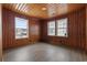 Inviting bedroom featuring paneled walls, complemented by natural light from double windows with views at 3202 Inland St., North Myrtle Beach, SC 29582