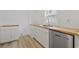 Clean kitchen area with wood countertops, stainless steel dishwasher and white cabinets at 3202 Inland St., North Myrtle Beach, SC 29582