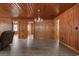 Spacious living room with wood walls, wood ceiling, hardwood floors, and doors to other rooms at 3202 Inland St., North Myrtle Beach, SC 29582