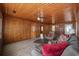 Cozy living room with wood paneling, ceiling fan, and comfortable furnishings at 3202 Inland St., North Myrtle Beach, SC 29582