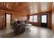Spacious living room features a wood paneled wall, a fan, and multiple windows at 3202 Inland St., North Myrtle Beach, SC 29582
