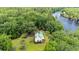 Aerial view of lake front home surrounded by lush greenery with a private dock at 3231 Center Rd., Georgetown, SC 29440