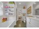 Hall bathroom with tub, white vanity, and tile floors and view into the bedroom at 3231 Center Rd., Georgetown, SC 29440