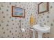 Charming half-bathroom with vintage wallpaper and pedestal sink, adding character at 3231 Center Rd., Georgetown, SC 29440