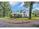 Exterior view of a two-story home featuring a carport and green lawn at 3231 Center Rd., Georgetown, SC 29440