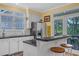 Well-appointed kitchen with white cabinets, a breakfast bar, and backyard views at 3231 Center Rd., Georgetown, SC 29440