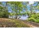 Path leads to private dock, offering serene lake views amidst lush greenery and mature trees at 3231 Center Rd., Georgetown, SC 29440