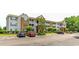 Apartment building with a parking lot and landscaping at 3774 Hitchcock Way # 836, Myrtle Beach, SC 29572