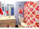 Bright bathroom with wood vanity, white sink, and decorated shower curtain at 3774 Hitchcock Way # 836, Myrtle Beach, SC 29572