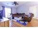 Comfortable living room featuring hardwood floors, a ceiling fan, and a large sectional at 3774 Hitchcock Way # 836, Myrtle Beach, SC 29572