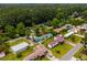An aerial view showcases this well-treed neighborhood with uniquely-situated mobile home properties at 3839 Woodridge Circle, Little River, SC 29566