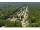 An aerial view of the neighborhood, surrounded by lush greenery and mature trees at 3839 Woodridge Circle, Little River, SC 29566