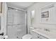 Bright bathroom featuring a glass-enclosed shower, white vanity, and decorative mirror at 3839 Woodridge Circle, Little River, SC 29566