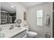 Clean bathroom with a tile shower, commode, and modern sink at 3839 Woodridge Circle, Little River, SC 29566