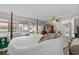 Spacious bedroom featuring wooden floors, ceiling fan, double closets and several windows looking out into the yard at 3839 Woodridge Circle, Little River, SC 29566