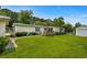 This property features a well-maintained lawn, a wooden deck, and a fenced yard at 3839 Woodridge Circle, Little River, SC 29566