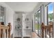 Bright hallway with white room divider, wood railing and sliding glass doors at 3839 Woodridge Circle, Little River, SC 29566