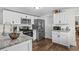 Well-lit kitchen featuring stainless steel appliances, granite counters, and sleek white cabinetry at 3839 Woodridge Circle, Little River, SC 29566