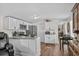 Updated kitchen with white cabinets, stainless steel appliances, a breakfast bar, and hardwood floors at 3839 Woodridge Circle, Little River, SC 29566