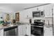 Kitchen showcasing stainless steel appliances, granite counters, and bright white cabinets at 3839 Woodridge Circle, Little River, SC 29566