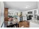 Open-concept kitchen featuring stainless steel appliances, granite countertops, and white cabinets at 3839 Woodridge Circle, Little River, SC 29566