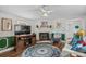 Inviting living room featuring a fireplace, ceiling fan, hardwood floors, and stylish decor at 3839 Woodridge Circle, Little River, SC 29566