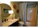 Bright bathroom with a marble countertop, a round mirror, and a shower-tub combination at 390 Lands End Blvd. # 4-201, Myrtle Beach, SC 29572