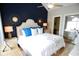 Modern bedroom with a vaulted ceiling, stylish mirrors, and a comfortable bed at 390 Lands End Blvd. # 4-201, Myrtle Beach, SC 29572