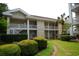 Attractive two-story building with well-maintained landscaping, offering a welcoming curb appeal at 390 Lands End Blvd. # 4-201, Myrtle Beach, SC 29572