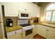 Bright kitchen featuring white cabinetry, granite countertops, and modern appliances at 390 Lands End Blvd. # 4-201, Myrtle Beach, SC 29572