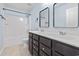 Bathroom featuring a double sink vanity, bathtub with shower, and neutral tile flooring at 4115 Alvina Way, Myrtle Beach, SC 29579