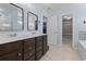 Bathroom showcasing a double sink vanity, bathtub shower combo, and adjacent walk-in closet at 4115 Alvina Way, Myrtle Beach, SC 29579