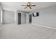 Spacious bedroom with plush carpet, ceiling fan, TV, walk-in closet, and ensuite bathroom at 4115 Alvina Way, Myrtle Beach, SC 29579