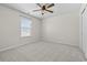 Well-lit bedroom with plush carpet, ceiling fan, and a window overlooking the scenic outdoors at 4115 Alvina Way, Myrtle Beach, SC 29579